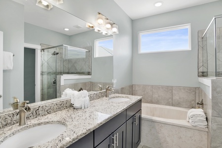 The master bathroom has a double vanity and a soaking tub