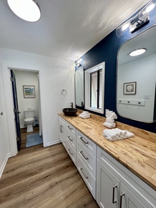 The bathroom is accessible from hallway and master bedroom