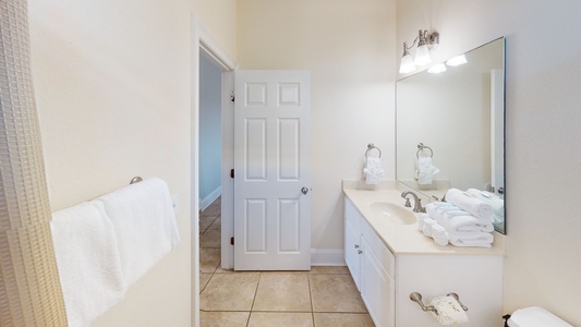 1st floor shared hall bathroom with a tub/shower combo