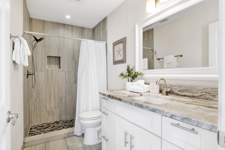 Private bathroom with walk-in tile shower