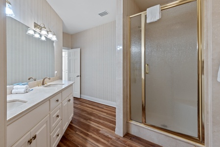 Private bath in Bedroom 2 with a double vanity and a walk-in shower