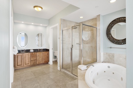 The private bathroom has double vanities, walk-in shower and jetted tub