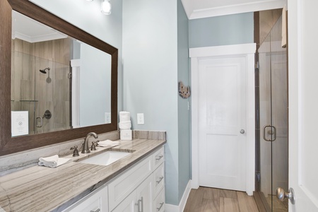 The private bathroom has a single vanity with granite counters