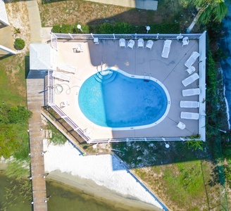 Lounge chairs at the community pool plus awesome views and a sandy area