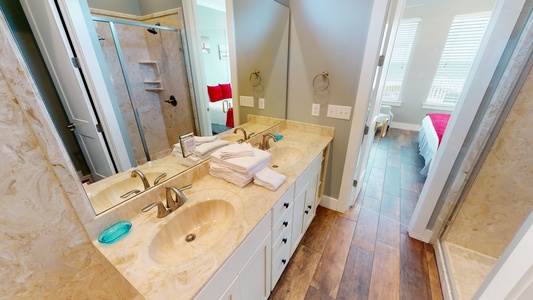 The private bathroom in bedroom 1 has a double vanity, a walk-in shower and a private water closet