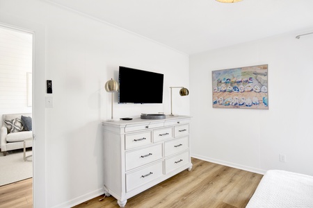 The guest bedroom has a TV and views of the water