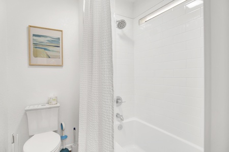 The bathroom has a tub/shower combo