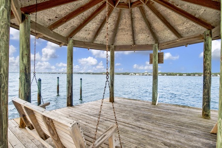 Shaded area with a swing at the end of the pier