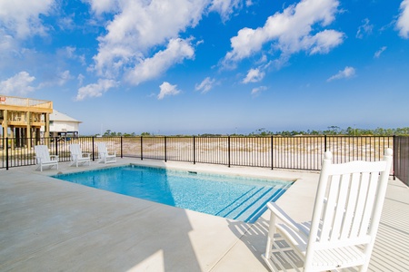 The pool is located behind the home