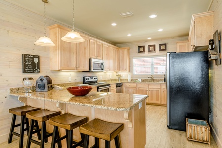 Kitchen features granite countertops and stainless appliances