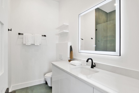 The private bathroom offers a walk-in tile shower