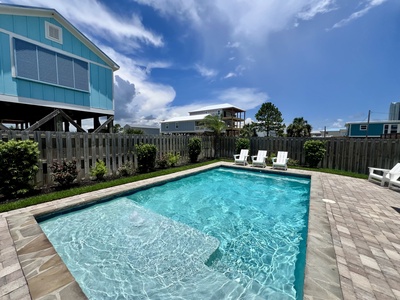 The pool has a tanning ledge and seating