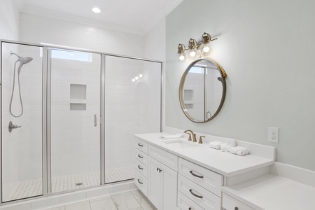 The guest bathroom features a walk-in, tile shower
