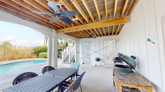 Covered grilling and dining area near the pool deck