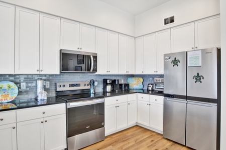 The fully equipped kitchen offers stainless appliances