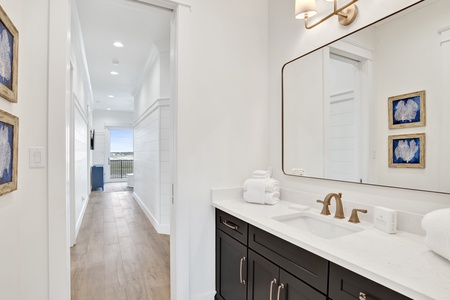 The shared bathroom is accessible from one bedroom and the hall