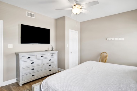 1st floor guest bedroom has a TV and shares the hallway bathroom
