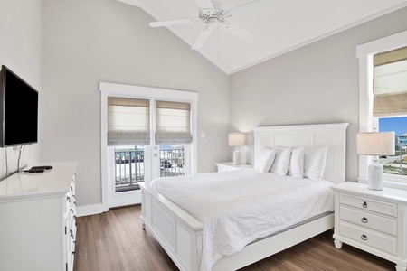 The guest bedroom has a Queen size bed, TV, balcony access and bathroom