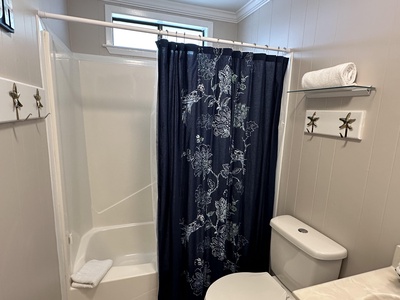 Shared bathroom for bedrooms 3 & 4 with a tub/shower combo