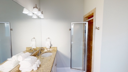 The private bath in Bedroom 7 has a double vanity and a walk-in shower