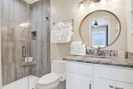 The private ensuite features a walk-in tile shower