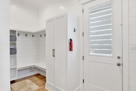 1st floor entrance into the home with a storage area and elevator