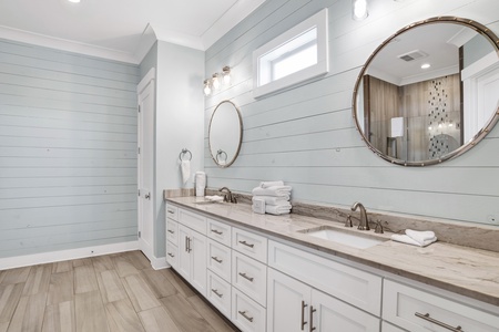 The spacious bathroom has double vanities
