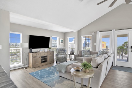 The living room offers a TV and large sectional sofa