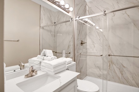 1st floor hallway bathroom has a walk-in, tile shower