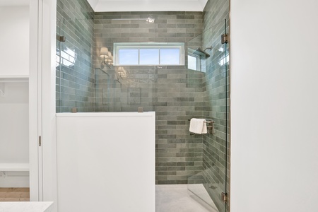 It features a walk-in, tile shower
