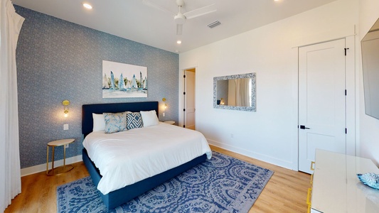 The master bedroom on the first floor has a king bed, water views and balcony access