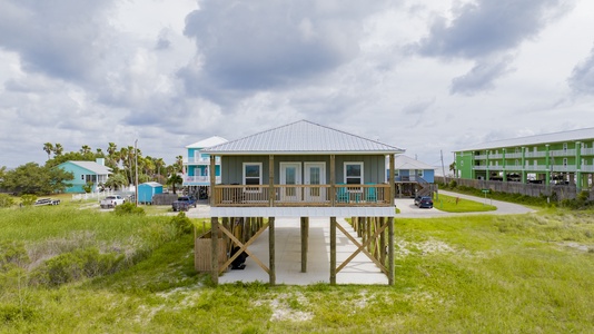 The carport offers a charcoal grill and picnic table for outdoor dining