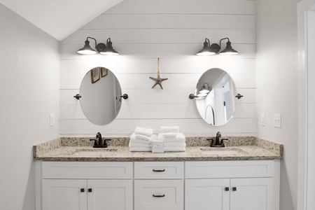 The primary bathroom features double vanities