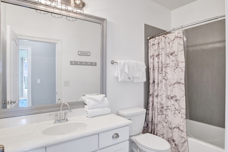 2nd floor hall bathroom (bunk rooms share bathroom) with a tub/shower combo