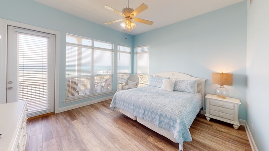 Master bedroom featuring a king bed, TV with cable, access to the back deck and an attached, private bathroom.