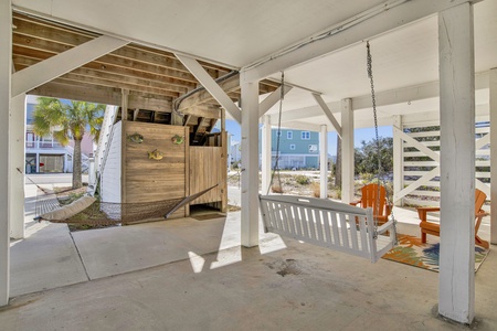 Hammock, swing and lounging area under home