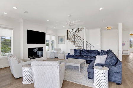 The living room offers a sectional sofa, TV and fireplace