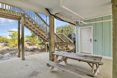 Covered parking area with picnic table for outdoor dining