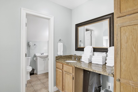 A vanity with sink is located in the bedroom - Jack and Jill style bathroom is shared with the bunk bedroom