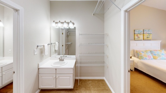 Bedroom 2 has a private vanity in the large attached closet - this leads to a shared bath with a tub/shower combo