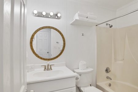 The shared hall bathroom features a tub/shower combo