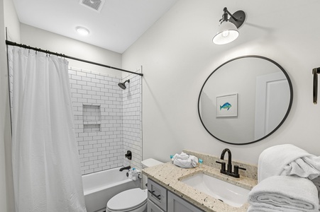 Shared bathroom with a tub/shower combo