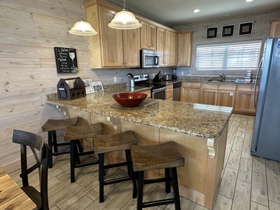 Kitchen features granite countertops and stainless appliances