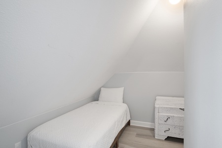 Small sleeping room (#2) on the 3rd floor with a sliding barn door