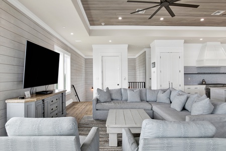 The main living room offers plenty of seating and a flat screen TV