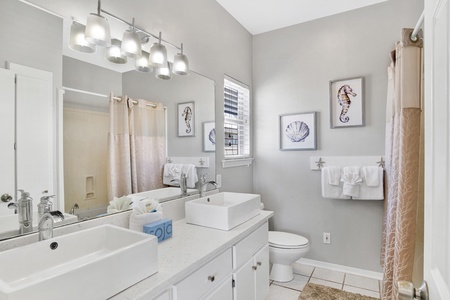 The private master bath is equipped with double sinks and a jetted tub/shower combo