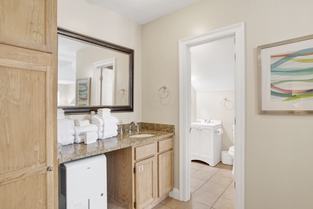A vanity with sink is located in the bedroom - Jack and Jill style bathroom is shared with the bunk bedroom