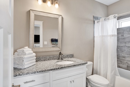 The private bath in Bedroom 2 has a tub/shower combo