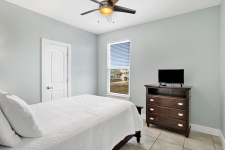 Bedroom 5 has a full bed, TV and ceiling fan