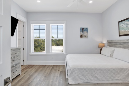 Summertime Blues II- 1st Floor Master bedroom with a king bed, TV, ceiling fan and a private bathroom